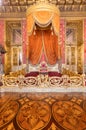 Old throne room interior with chair in luxury palace. Red and gold antique Baroque style