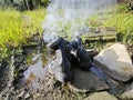 old thrown away leather boot on flame in the farm. Royalty Free Stock Photo