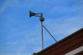 Tornado Siren Thunderbolt Mounted On Top Of Building With Guy Wires