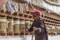 Old Tibetan women turning prayer wheels at a monastery