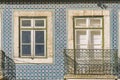 Old tiled facade with window and balcony