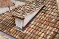 An old tiled roof of a European house with a dormer Royalty Free Stock Photo