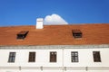 Old tiled roof with two attic windows and chimney Royalty Free Stock Photo