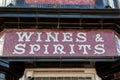 an old tiled wines and spirits sign on the front of an old British pub