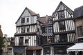 Old and tilted houses at Rue Eau de Robec in Rouen on a rainy day. Rue Eau-de-Robec is one of the main tourist streets