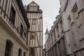 Old and tilted houses at Rue Eau de Robec in Rouen on a rainy day. Rue Eau-de-Robec is one of the main tourist streets