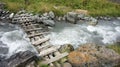 Old timber bridge at mountain river