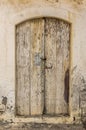 Old timber door in the scuffed wall Royalty Free Stock Photo