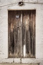 Old timber door in the scuffed wall Royalty Free Stock Photo