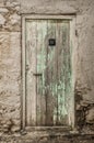 Old timber door in the scuffed wall