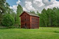 Old timbered two story barn on a green summer field Royalty Free Stock Photo