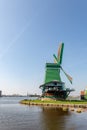 Old time dutch wind mills next to a pond under open sky Royalty Free Stock Photo