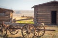 Old Time Vintage Antique Wood Wagon and Log Cabins.