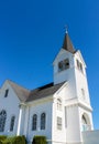 White church building against turquoise blue sky