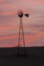 Old time windmill at sunset in Kansas Royalty Free Stock Photo