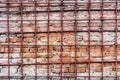 An old and time-worn red brick wall behind a metal grating Royalty Free Stock Photo