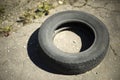 Old tire. One wheel on road. Old rubber thrown on street. Item from car Royalty Free Stock Photo