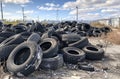 Old tires dumped in landfill. A pile of old tires at an industrial site Royalty Free Stock Photo