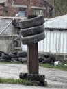 old tires stacked on a metal girder
