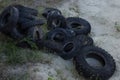 Old tires of trucks and cars, lie in a heap. Rubber dump