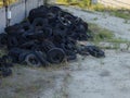 Old tires of trucks and cars, lie in a heap. Rubber dump