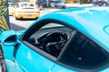 From old to new, Porsche sports cars parked near an art mural in a downtown art Miami district.