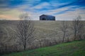 Old Old tobacco barn with harvested corn field. Royalty Free Stock Photo