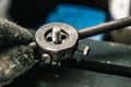 Old tools ,Mechanic using Taps and Dies tool Making Internal and External Threads nut at motorcycle garage .selective focus