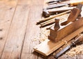 Old tools: wooden planer, hammer, chisel in a carpentry worksho
