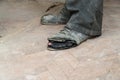 Old torn boots on the man`s feet Royalty Free Stock Photo