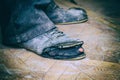 Old torn boots on the man's feet Royalty Free Stock Photo