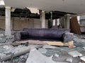 Old torn sofa in the demolished abandoned building