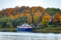 An old tourist pleasure motor ship moored to the pier on the shore of Volkhov River at hazy autumn morning