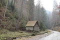 Old tourist wooden house in forest in mountains. autumn nature landscape. selective focus on the house Royalty Free Stock Photo