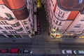 Old tower in Brno city and view down to main street from above where is car parking spots and people waling on main street during