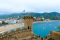 Old tower and stone fortress walls against background of resort town of Tossa de Mar, Spain Royalty Free Stock Photo