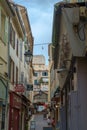 Antibes, France - June 13th 2018: A typical view of a street of Old Antibes town with cafes and restaurants.
