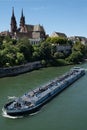 Red stone cathedral with two towers of Munster and an inland vessel in Basel, Switzerland