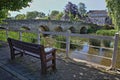 The Old Town Bridge on the river Avon with a wooden bench in the foreground, Bradford on Avon, UK Royalty Free Stock Photo