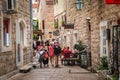 Old town in Budva. Ancient Roman houses, stone streets. Tourists. Shops and cafes. Montenegro, Balkans. Summer.