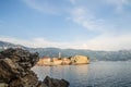 The Old Town Budva, Montenegro behind the rock. Beautiful blue sky with clouds over the roofs of the city on the Adriatic Sea Royalty Free Stock Photo