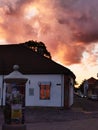 Old town building against dramatic red cloud sky