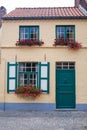 Old town building with door and flowers in windows. Royalty Free Stock Photo