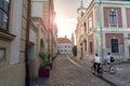 Old town of the famous Hungarian town Veszprem with motion blurred bikers at sunset Royalty Free Stock Photo