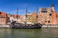 Old town of Gdansk with pirate sail ship reflected in Motlawa river, Poland