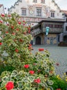 Old Town Hall building in Lindau city centre with flowering geranium bush in the foreground
