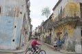 Old Town Havana looking down at side street with man riding cycle in foreground
