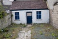 Old town house in Ireland, White walls, bright vibrant blue, Wooden window frames and door Royalty Free Stock Photo