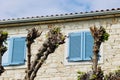 Beautiful blue window shutters in the classic mediterranean village house. Royalty Free Stock Photo