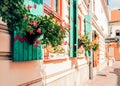 Real flowers in wicker baskets hanging from windows. Royalty Free Stock Photo